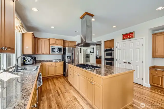 Gourmet kitchen with large island and plentiful cabinets for storage