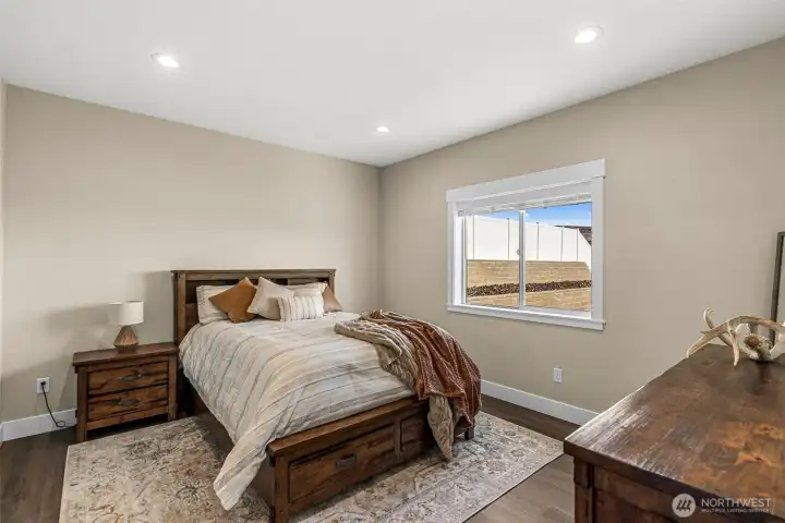 Primary bedroom with private feel on one side of the home