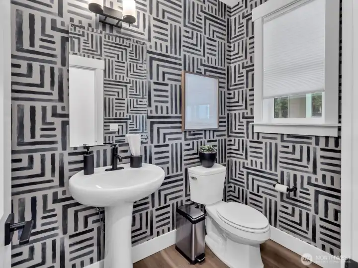 Powder room on main level for guests.  Photo is of model. Elements in home can vary.