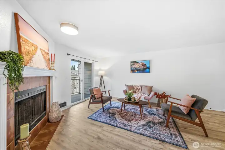 Lovely wood burning fireplace in the open living room.