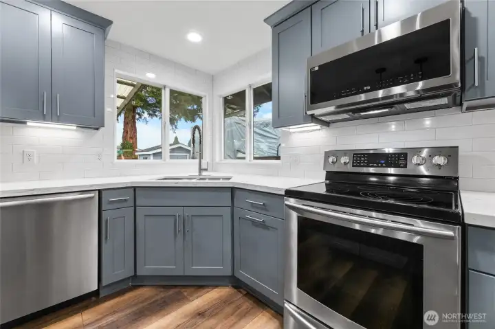 Updated Kitchen Cabinets, Tile Back Splash Extending up Wall to Ceiling.