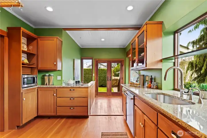 Such a large kitchen that  looks straight out into the back yard