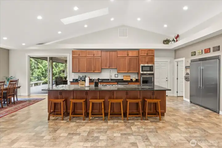 Kitchen w new commercial style refrigerator.