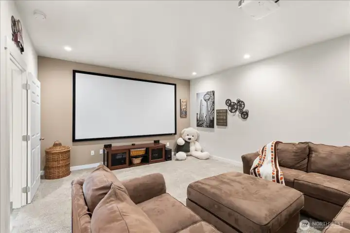 Massive bonus room currently staged as a theater, screen and projector stay.