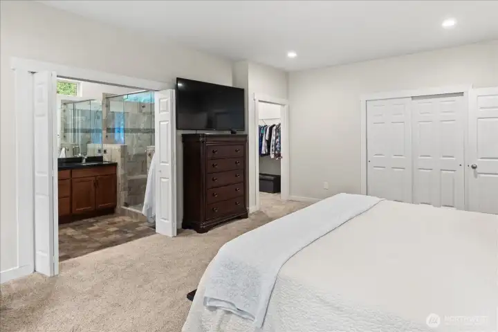 Primary walk in closet, additional closet and ensuite primary bath.