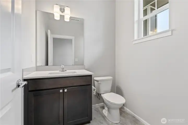 Main floor half bath. Ceramic tile floor.