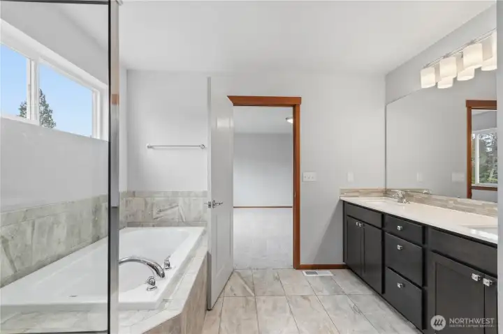 Primary bathroom with tub and separate shower.
