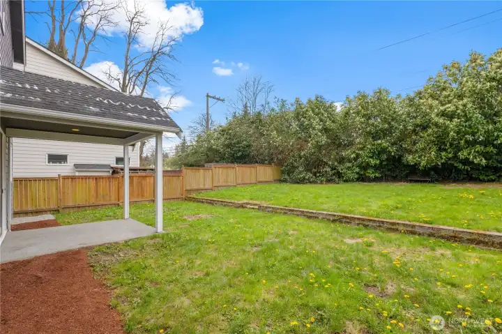 Large yard with garden and play areas. Set up badminton or volleyball.