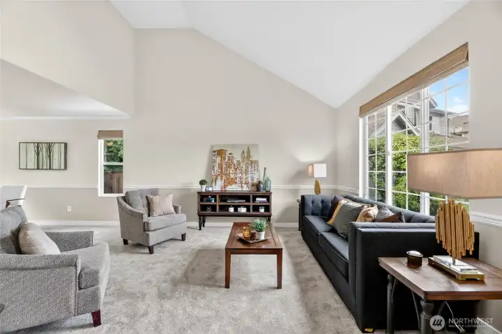 Natural-light filled living room with lofted ceilings, new carpet and paint.