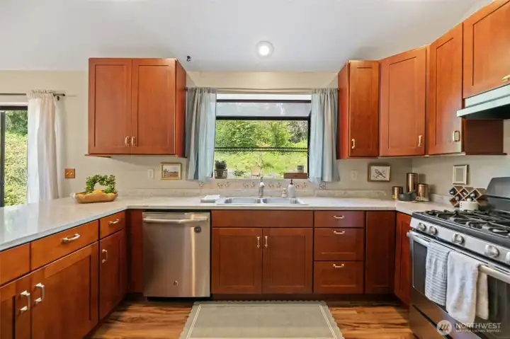 Stainless steel appliances, cherry cabinets, updated hardware and Corian countertops