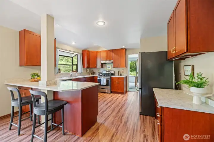 Stainless steel appliances, cherry cabinets, updated hardware and Corian countertops