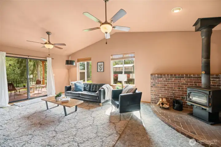 Wood burning stove in the family room off the entertaining deck. Beautiful vaulted ceiling to enjoy sunsets on the southwestern side of the home