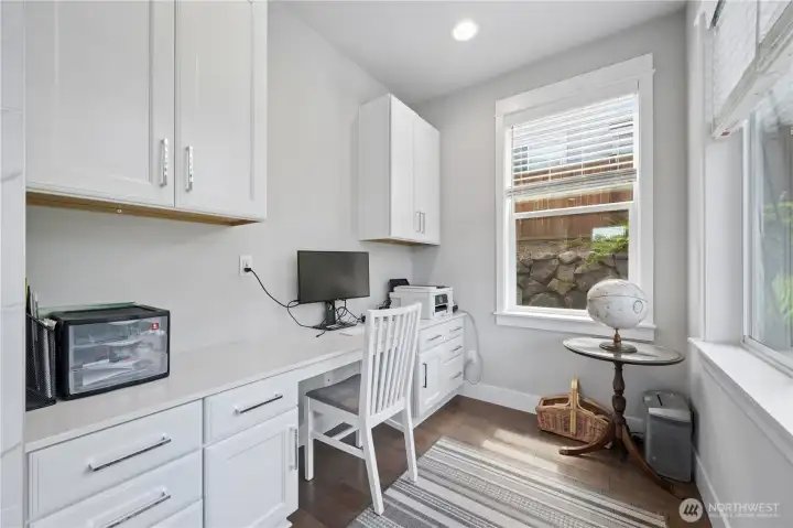 Office space on main, off living room. Close enough to everything, but with separation to concentrate.