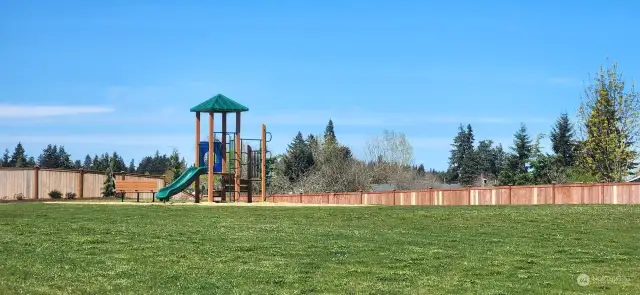 One of 2 community parks with play structure, picnic tables, benches and lots of green space!