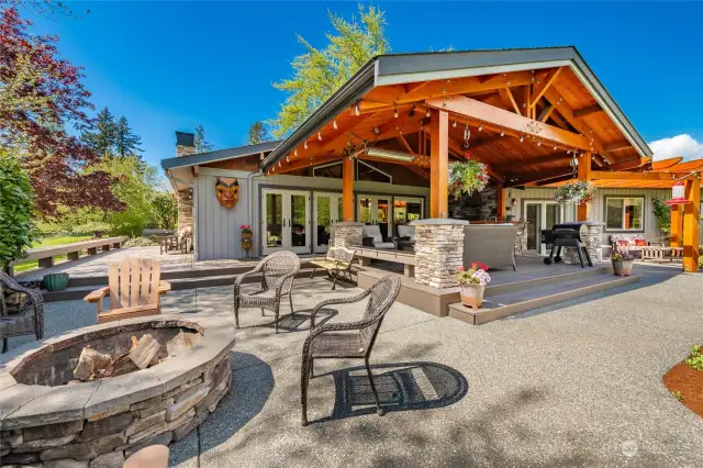 Superb outdoor living area overlooking the property w/ firepit