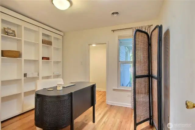 Built in murphy bed behind shelf!