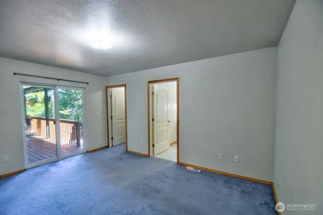 PPrimary bedroom looking toward back deck.  Primary bath and walk-in closet are to the right.