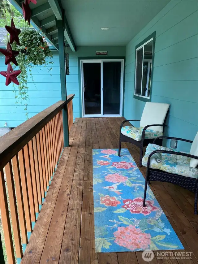 Back deck. Slider at the end lead to the primary bedroom.