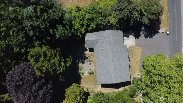 Aerial view of house and fenced back yard.