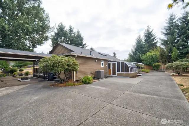 Driveway extends to the back of the house for added parking and convenience.