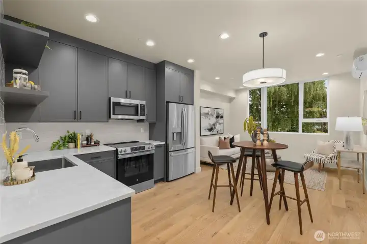 Soft-close cabinets, stone countertops, stainless steel appliances, and eye-catching black and white finishes elevate everyday living.