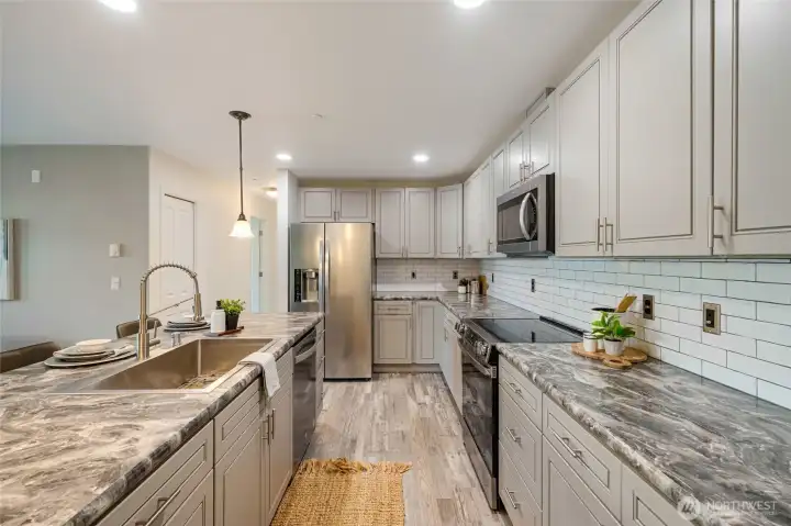 There is an abundance of counter and cabinet storage in the kitchen.