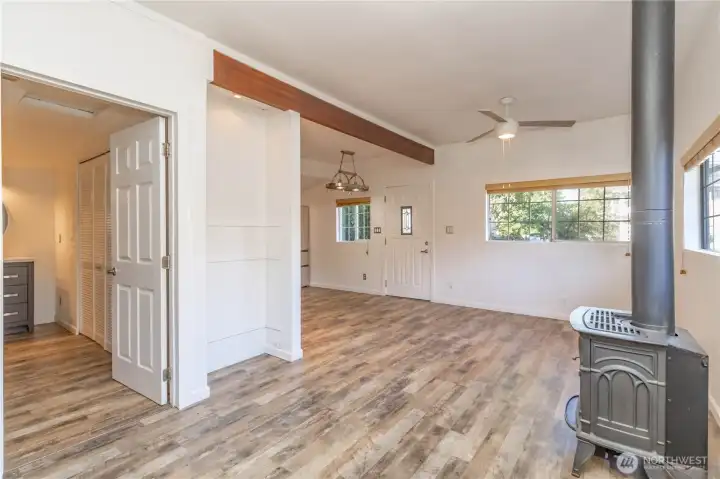 From the living space, the view looks toward the entry and kitchen, with the main bathroom and utility closet located just through the door to the left.
