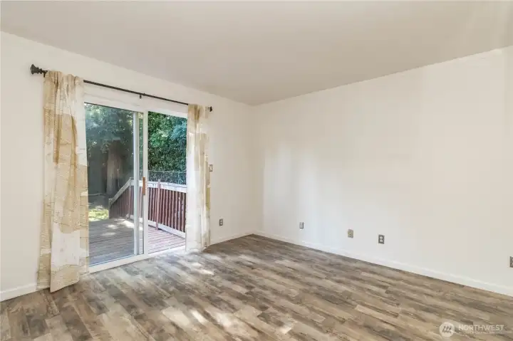 Spacious primary suite offering direct access to the back deck for easy indoor-outdoor living.