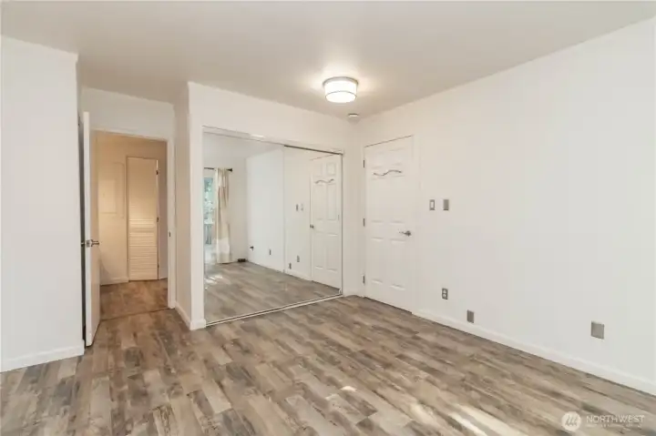 Alternate angle of the primary suite showcasing the space.