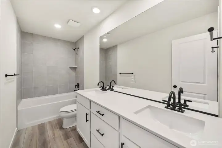 Upstairs bath. Photos of a previously completed home. Actual colors and finishes may vary. See site agent for details.