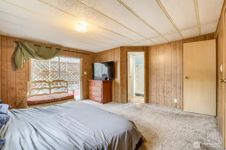 Primary bedroom with a sliding glass door to another covered patio