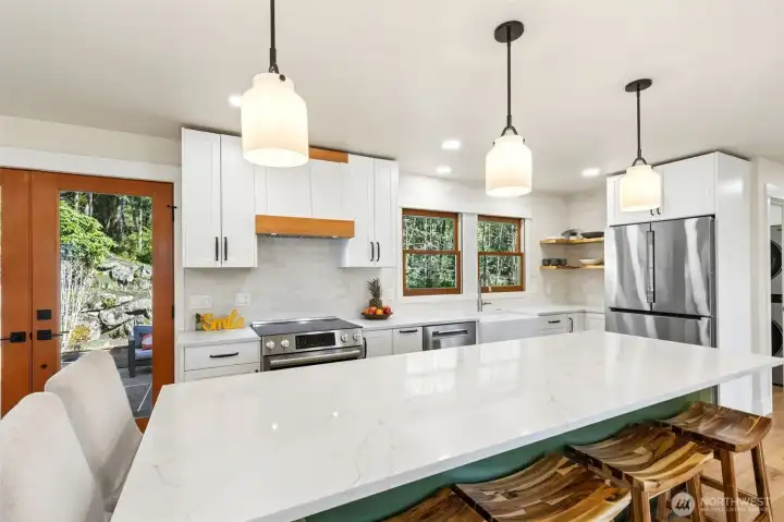 Updated island kitchen with quartz countertops and modern finishes.