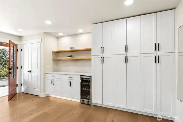 Coffee bar, wine fridge, and extensive cabinet storage.