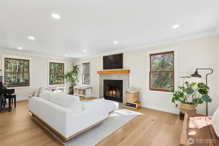 Spacious living room featuring a wood-burning fireplace.