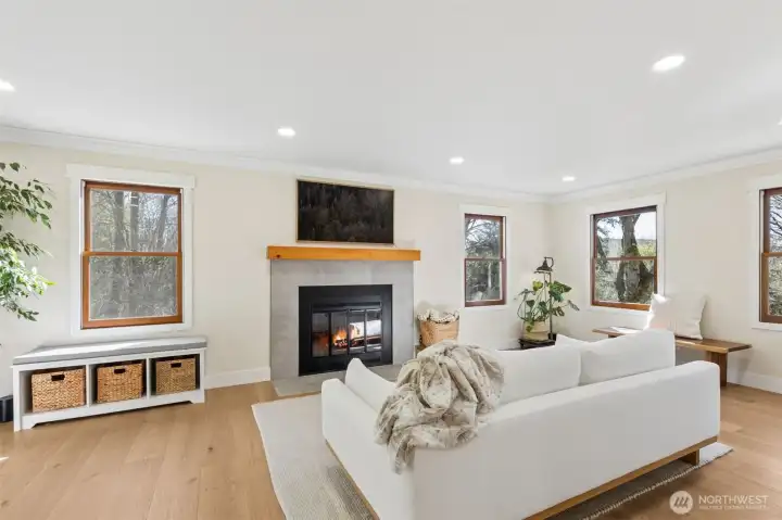 Spacious living room featuring a wood-burning fireplace.