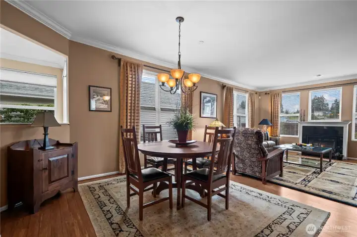 Gleaming bamboo floors, crisp crown molding, and expansive picture windows create a bright, inviting interior.