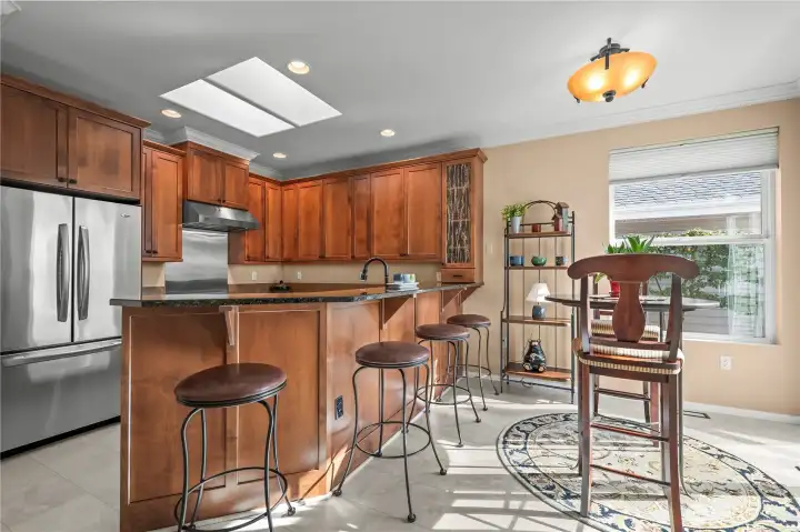 Beautifully remodeled kitchen with breakfast bar perfect for casual dining and morning routines.