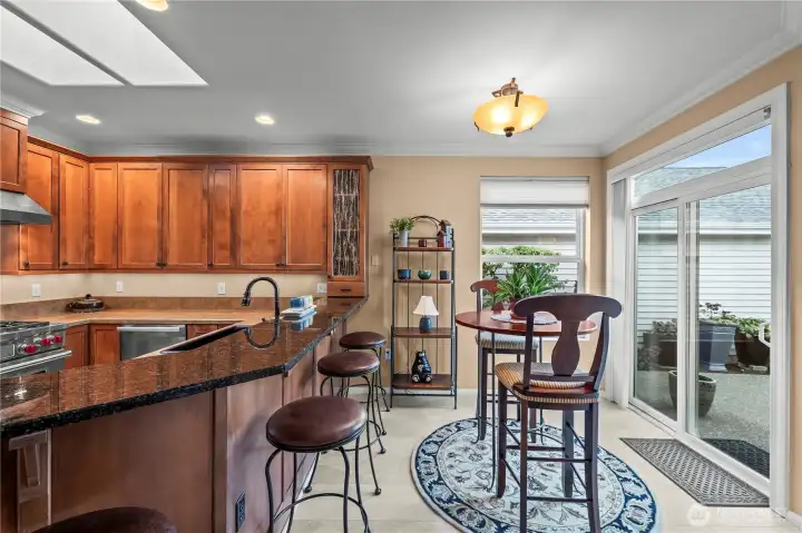 Adjacent eating nook with sliding doors leading to the expansive, fully fenced patio.