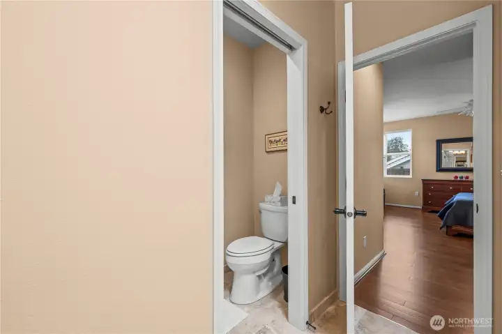 Private water closet separated by a pocket door.