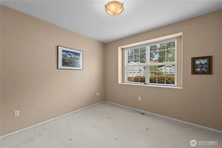 Guest bedroom located on the opposite end of the home for added privacy.