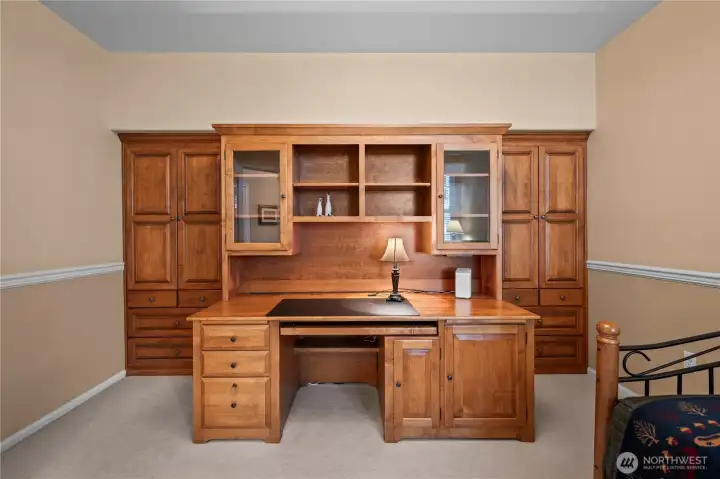 Matching built-in shelving with cabinets and drawers provides additional storage.