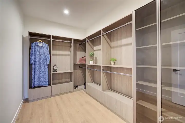 Built-ins complete the massive walk in closet for the primary bedroom