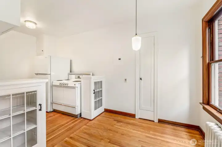 Eating area perfect for bistro table! Ironing board behind the cabinet. And beautiful glass display cabinets. Eating area perfect for bistro table! Ironing board behind the cabinet. And beautiful glass display cabinets.