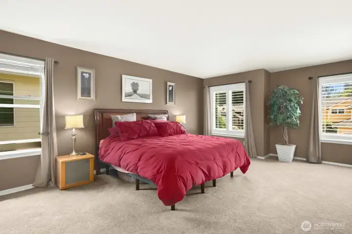 The spacious primary suite offers a true retreat, featuring generous proportions, abundant natural light, and plenty of room for a sitting area or home office. A peaceful sanctuary designed for comfort and relaxation.