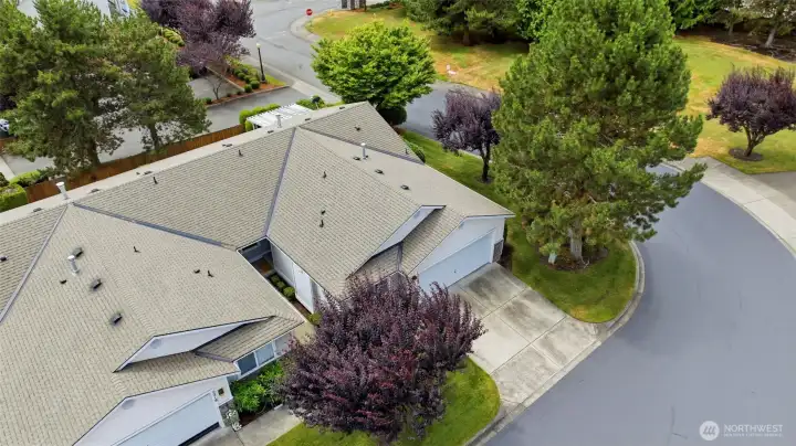 A bird's-eye view of this well-kept community: quiet streets, mature evergreens, and a prime corner setting.