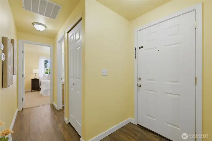 Step inside to durable Luxury Vinyl Plank flooring flowing through the entry and hallway — stylish, easy-care, and move-in ready.
