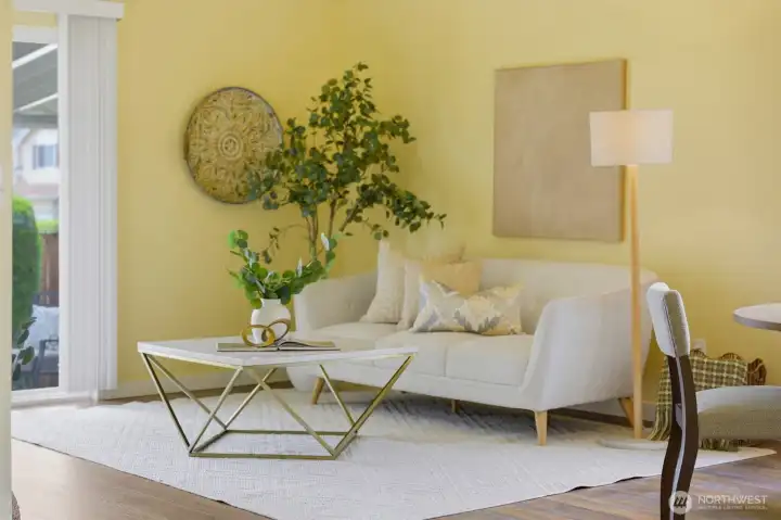 Sunlit living room with slider to the private covered patio — perfect for morning coffee or evening relaxation.