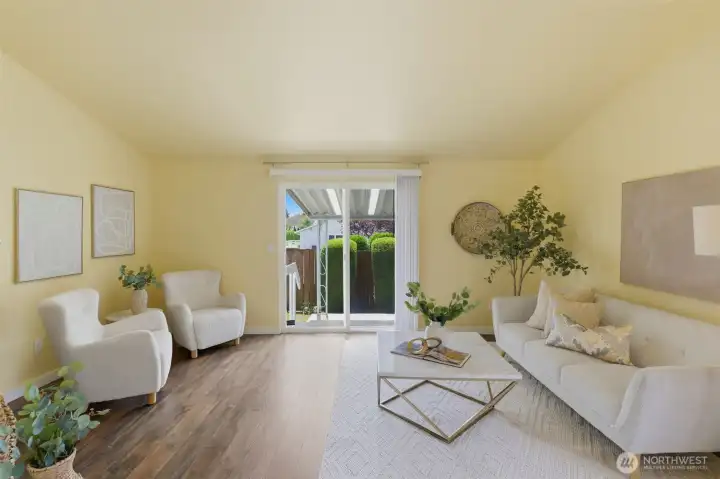 Spacious living room with vaulted ceiling and easy indoor-outdoor flow to the covered back patio.