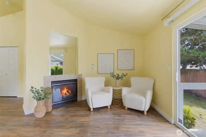 Gas fireplace with tile surround anchors this inviting sitting area beside the patio slider.