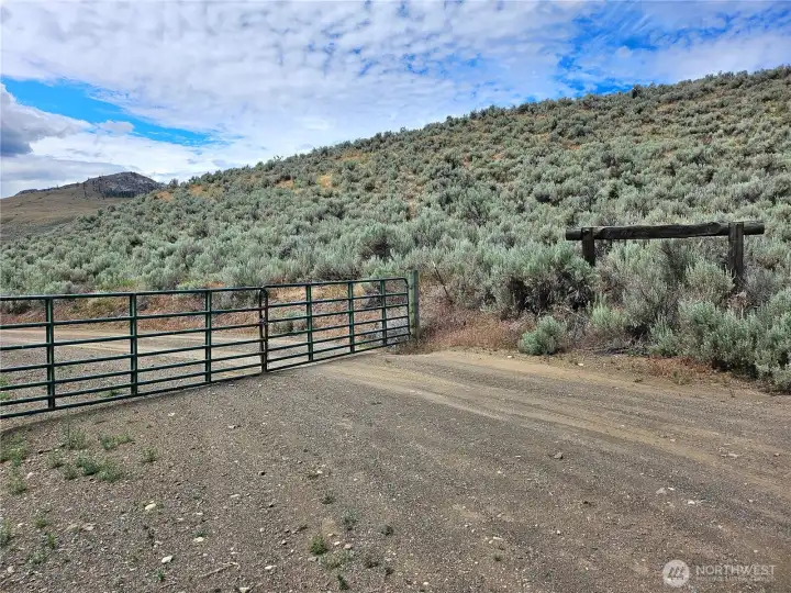 Gate leading into the property (need code). Wooden sign says Majestic Hills